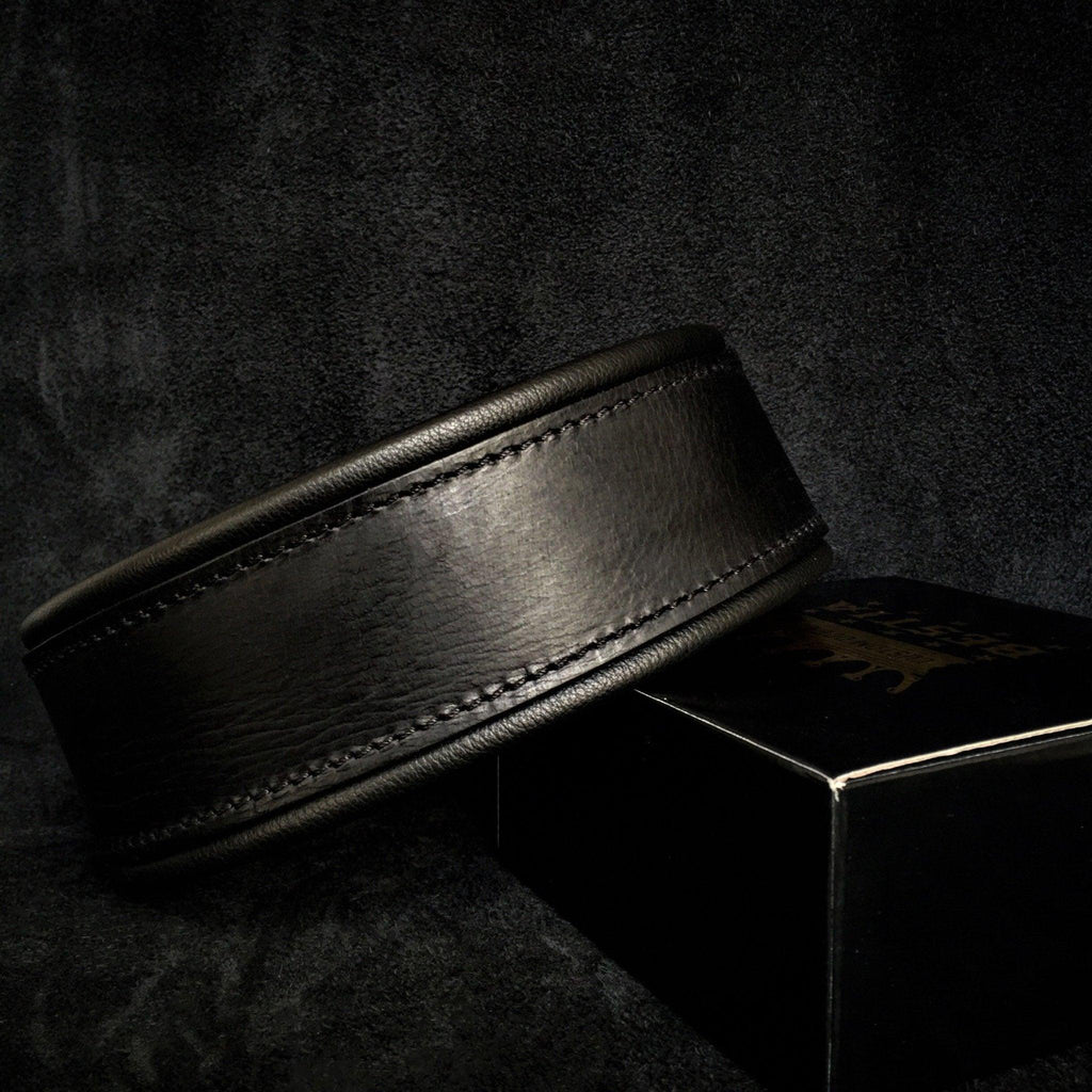 Black Leather Collar Belt on a Dark Textured Surface