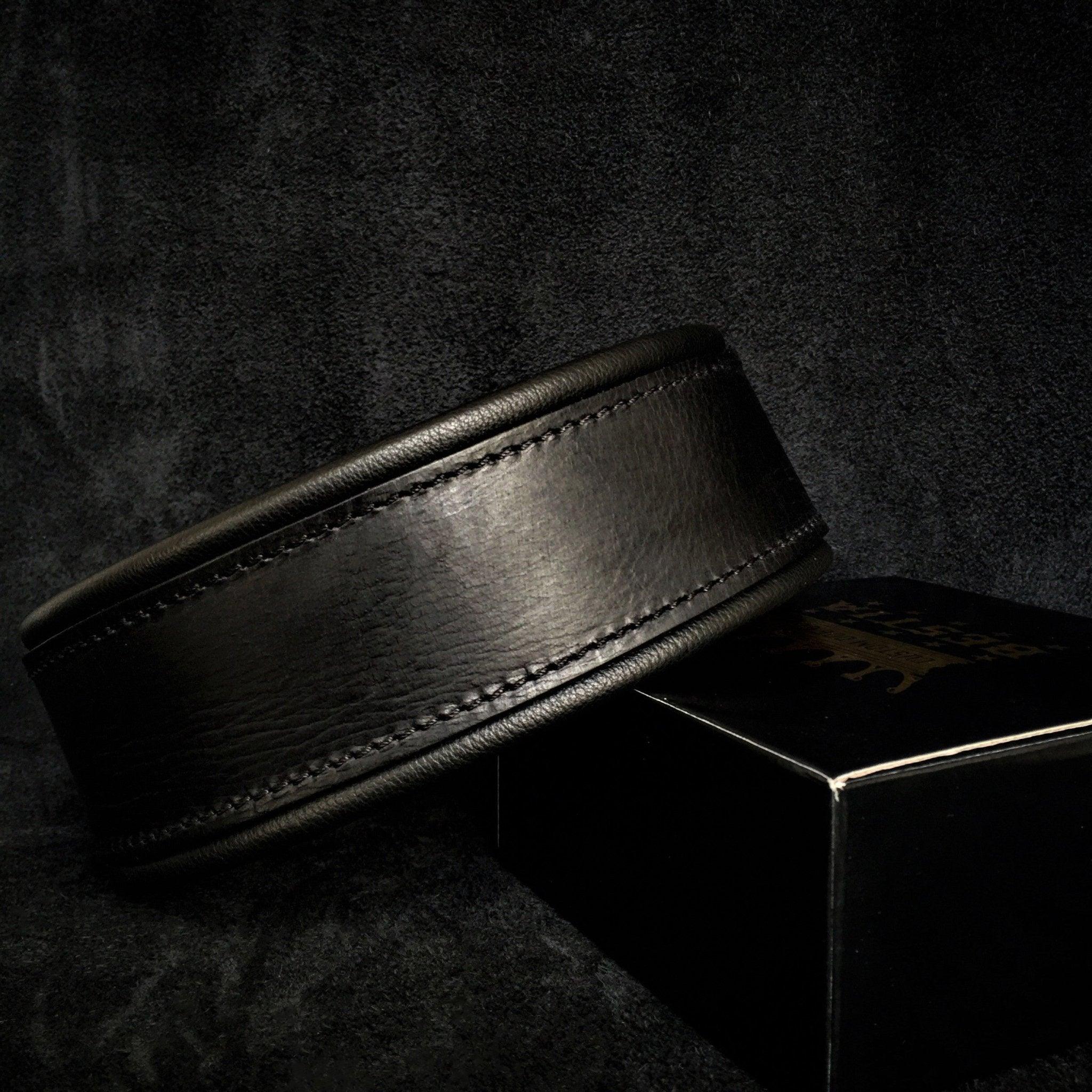 Black Leather Collar Belt on a Dark Textured Surface
